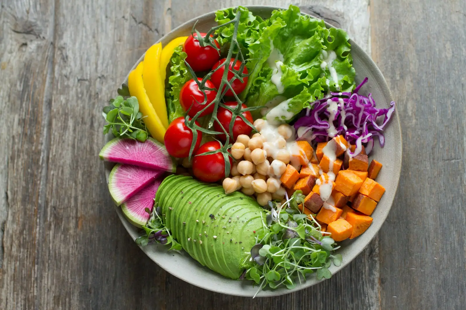 Colourful salad bowl with chickpeas, avocado and roasted vegetables