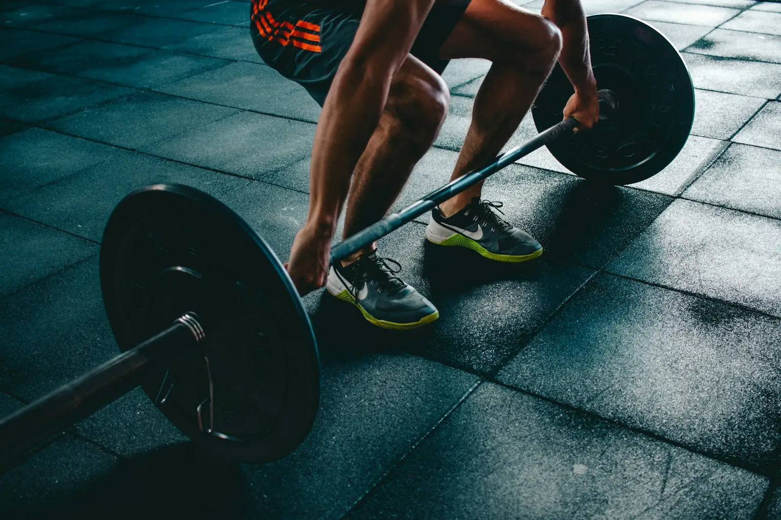 Barbell deadlift in a dark gym